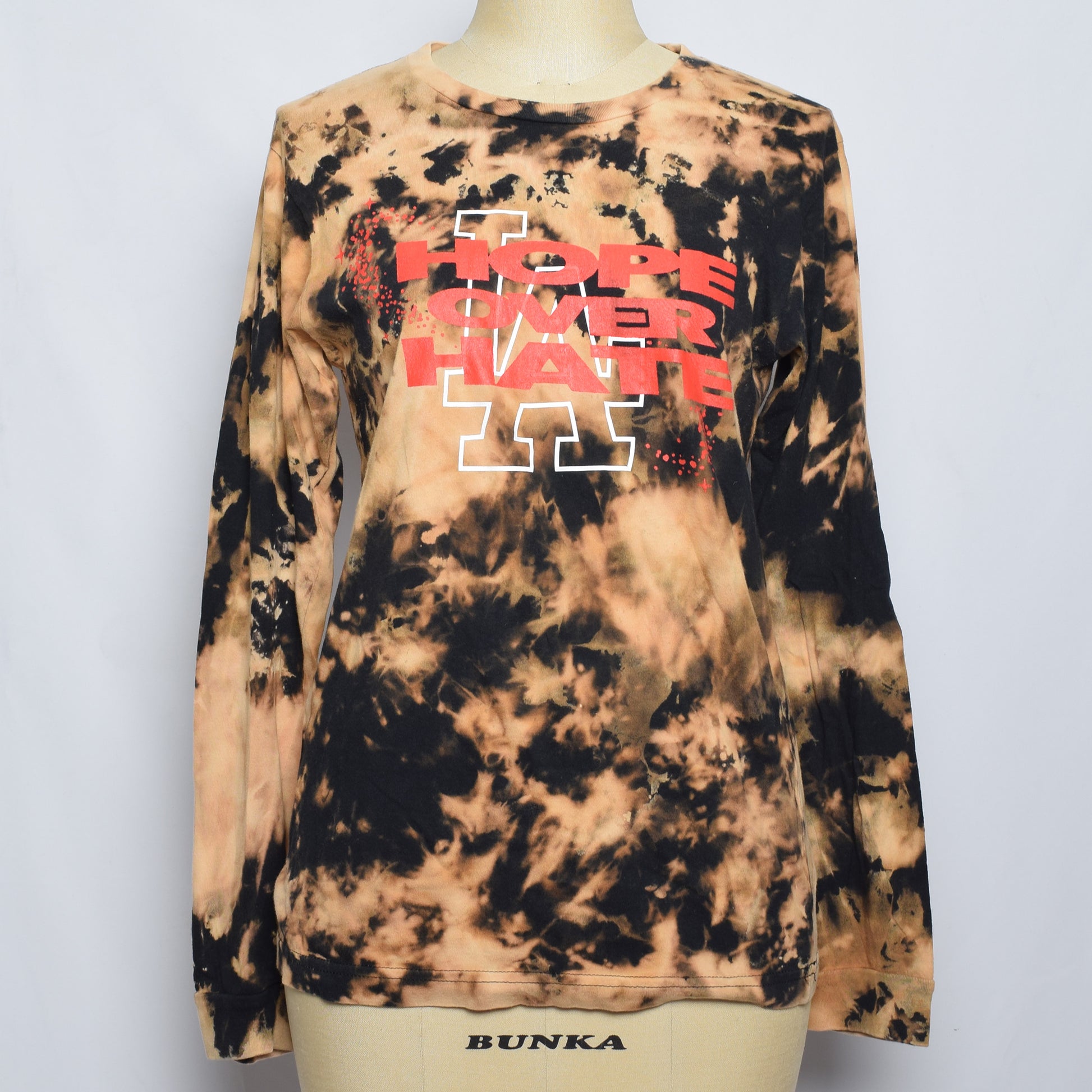 ブラウンのタイダイクロップド長袖TシャツにHOPE OVER HATEの赤色のプリント